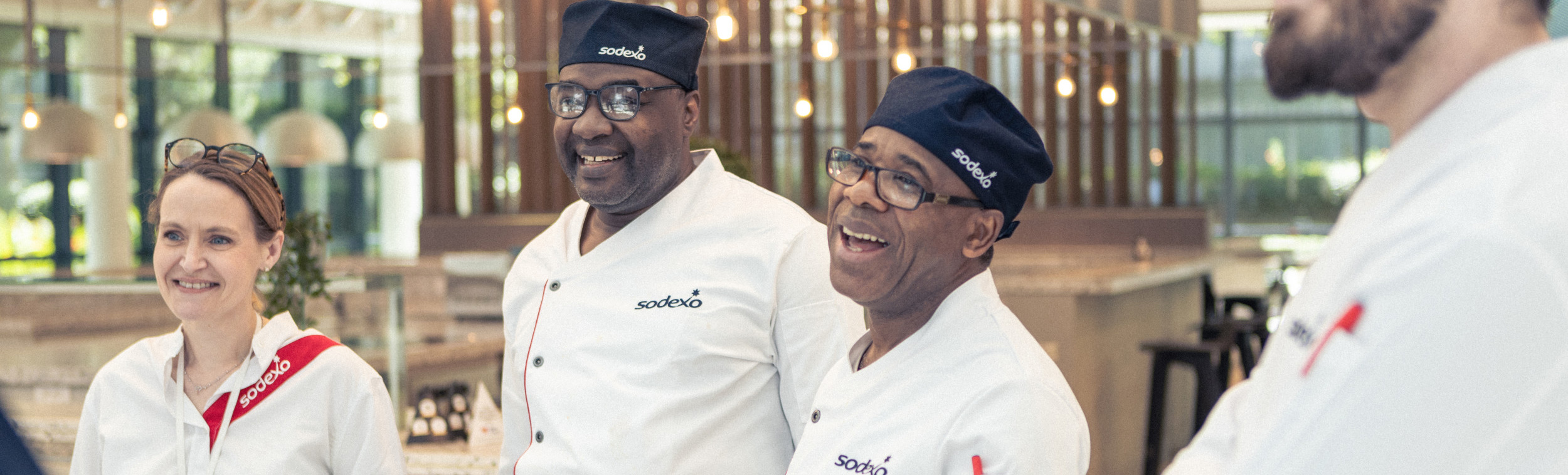 Four diverse Sodexo employees laughing