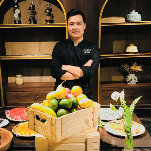 Chef showcasing different meals on a table